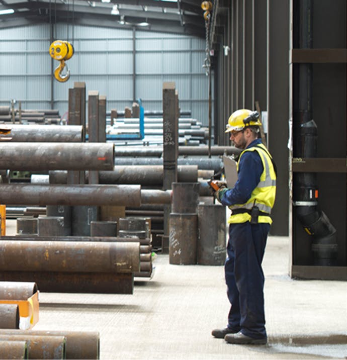 Man looking at steel in a construction site